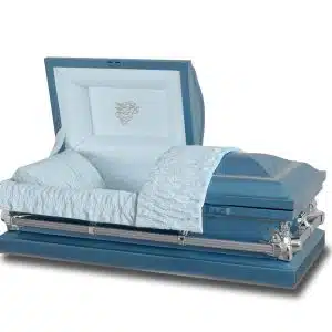 A blue casket with a polished exterior, featuring a partially open lid. The interior is lined with light blue fabric, and there is a decorative emblem on the inside of the lid. The design includes cushioned padding and metal accents.